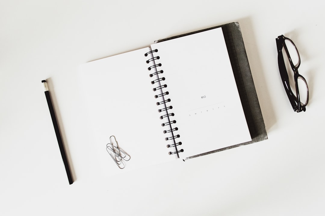 An overhead view of a modern desk with a laptop, coffee, and an open notebook, symbolizing the planning and checklist process for local business SEO.