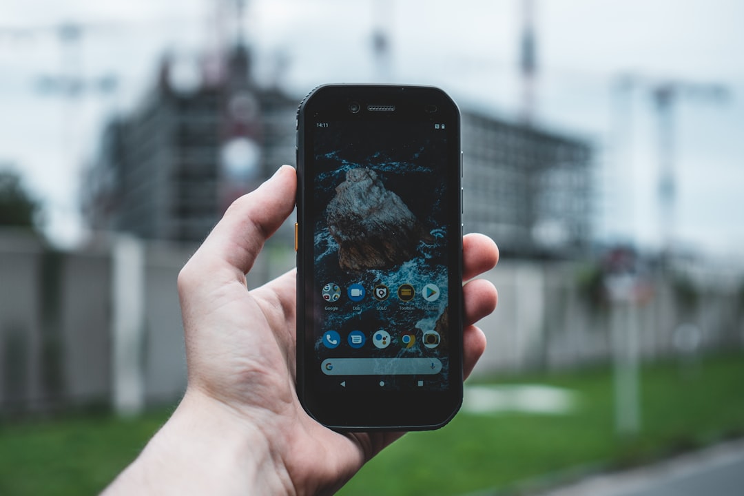 A person's hand holding a smartphone displaying an abstract, futuristic map interface, symbolizing a user interacting with a new AI search engine.