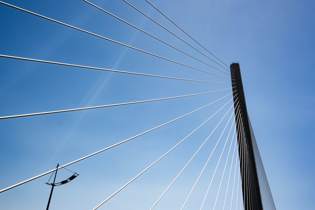 A photograph of a modern bridge with clean architectural lines against a clear sky, representing a strong, reliable infrastructure connecting a business to its customers.
