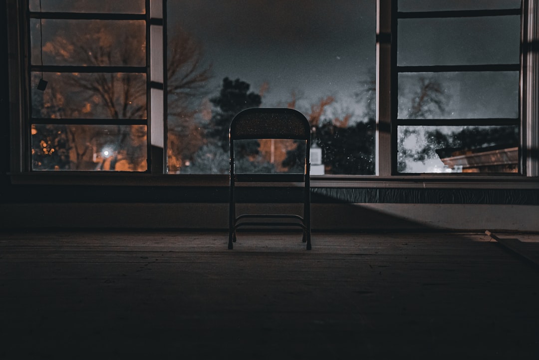 A single, sharp beam of white light cuts through a dark, hazy room, symbolizing a powerful AI solution bringing clarity and signal through data noise.