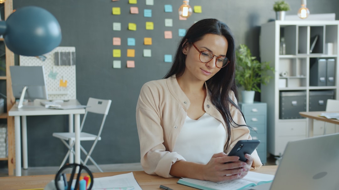 A smartphone sits on a modern, professional desk, its screen brightly displaying a map application with a location pin, illustrating a key digital asset for local business.