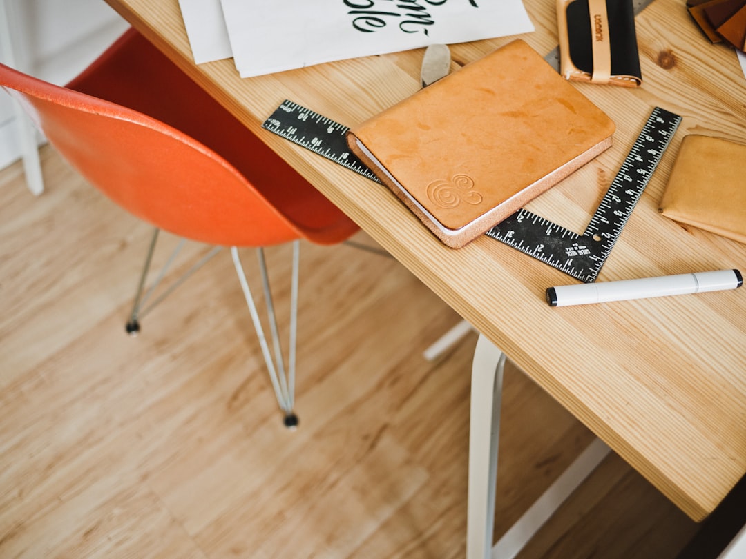 A clean, modern desk with a detailed architectural blueprint laid out alongside precision tools, symbolizing clarity and well-defined technical specifications.