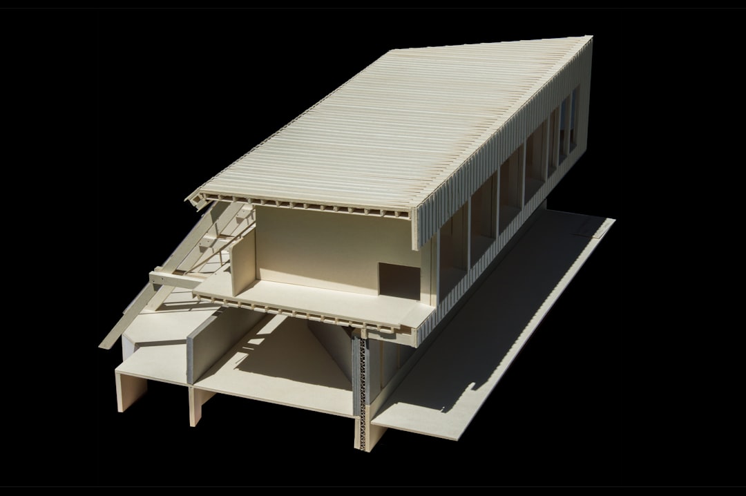 A detailed architectural model of a modern building sits on a clean, bright office desk, symbolizing strategic investment in digital assets.