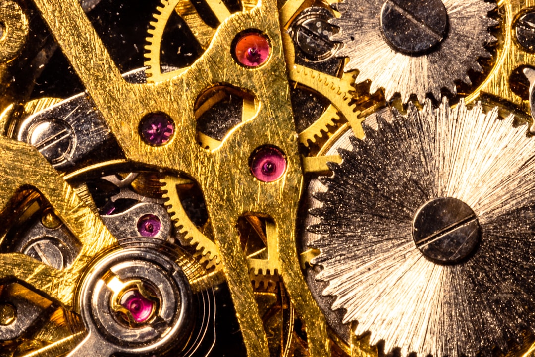 A macro photograph of clean, interlocking metal gears working together with precision, illustrating the engineering-first approach to building a verifiable data system.