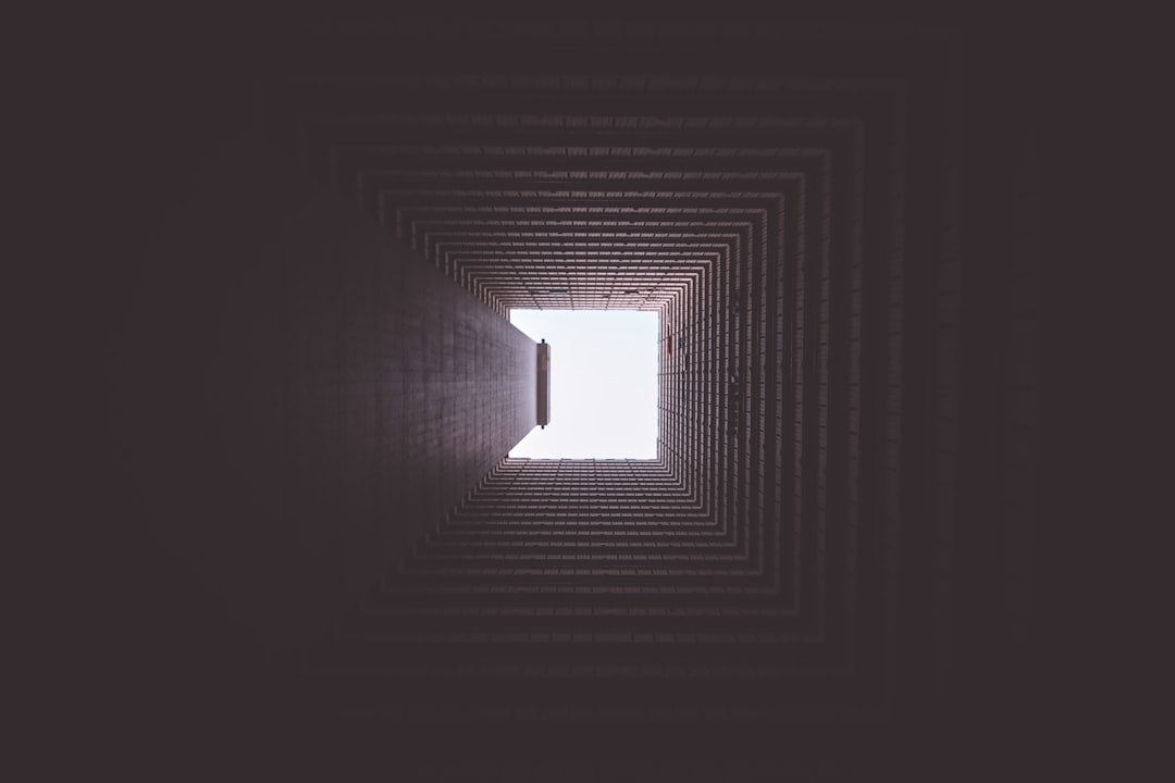 A top-down view of a complex maze with a single, clean, straight line drawn directly from the start to the finish, representing an efficient framework for escaping technical bloat.