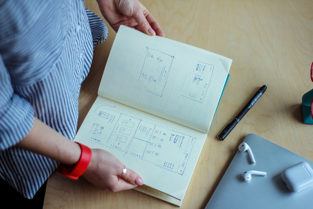 A clean, modern desk with architectural blueprints and drafting tools, representing the meticulous planning required to build web infrastructure as a capital asset.