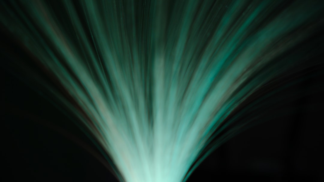 A single, sharp streak of white light cuts through a dark, abstract background, representing a clear signal overcoming data distortion and noise.