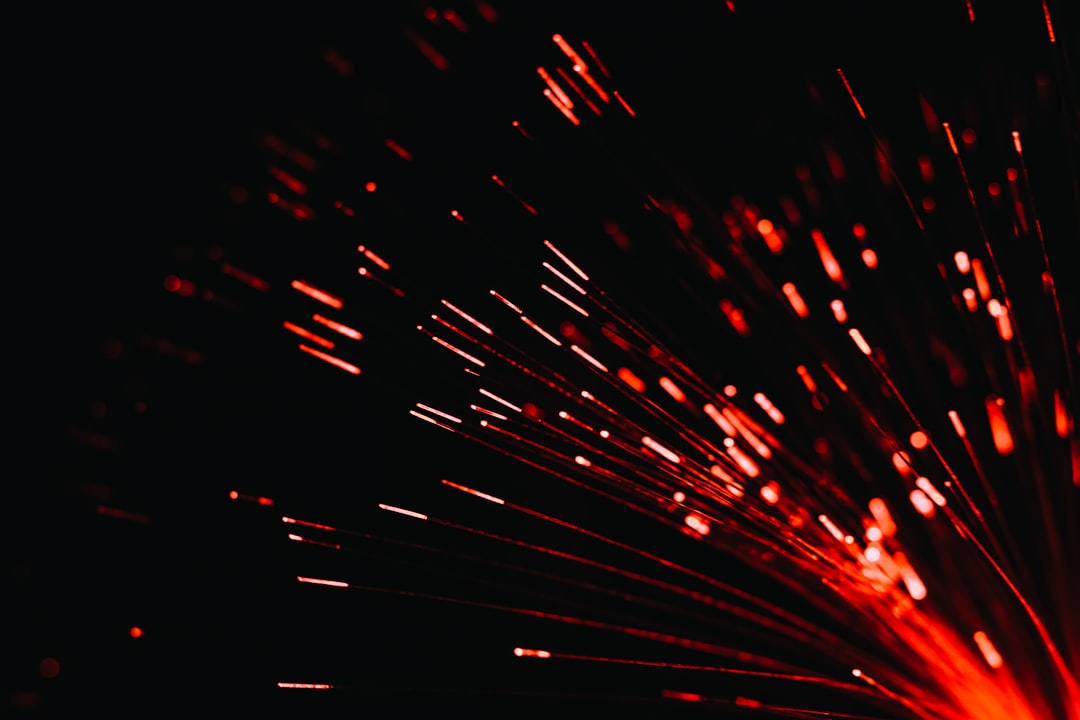 An abstract close-up of glowing fiber optic cables streaming light, illustrating the concept of clear, high-speed data signal flow and eliminating friction.