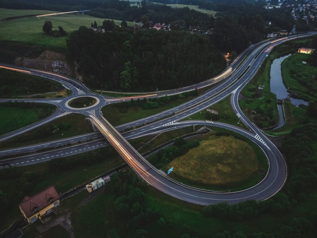 Aerial view of a clean, modern architectural landscape where a single path splits into two distinct directions, symbolizin...