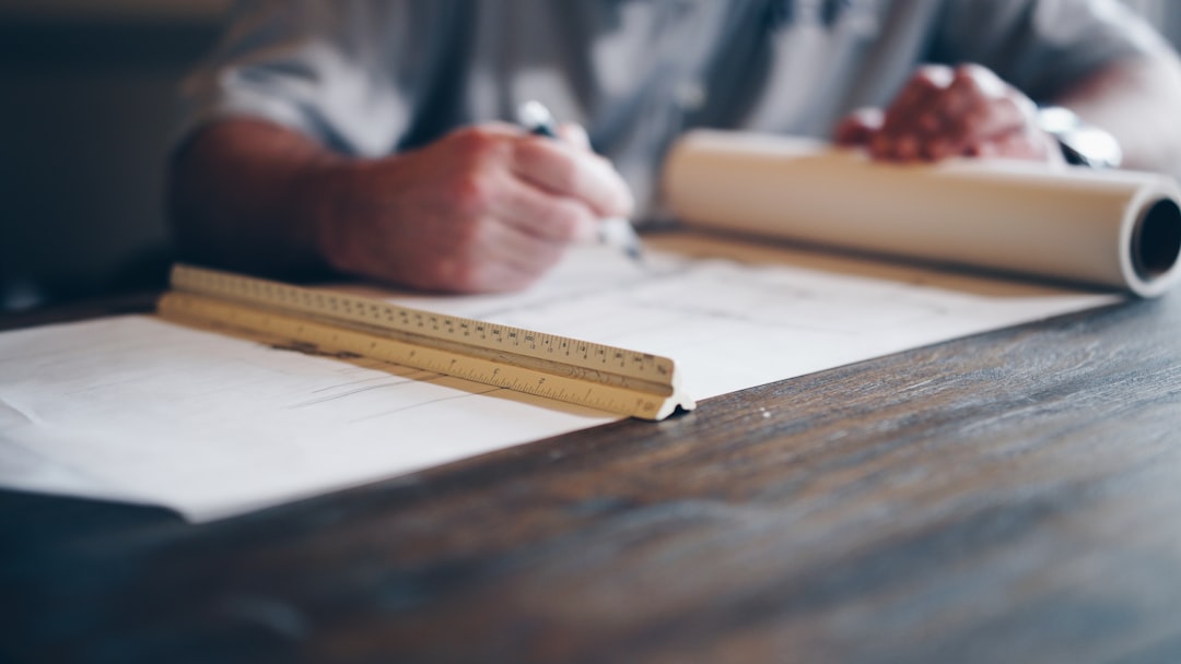 A clean, modern desk with architectural blueprints spread out, illustrating the transformation of SEO into a planned, durable digital infrastructure.