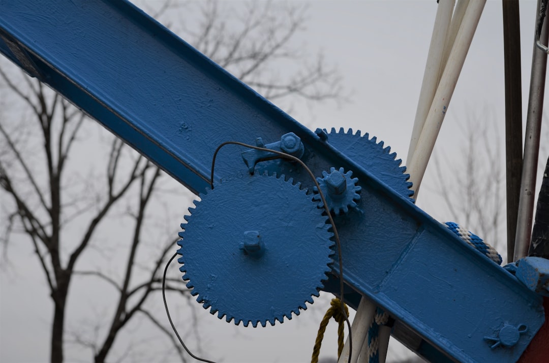 A close-up, professional photograph of two industrial metal gears with different tooth patterns that do not mesh, illustrating the concept of friction and system incompatibility.