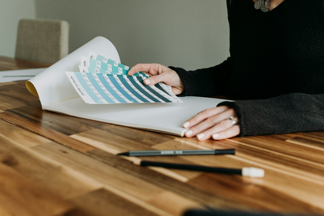 A professional, top-down view of an architectural blueprint spread neatly on a modern desk, symbolizing a structured, engineered model and a central source of truth.