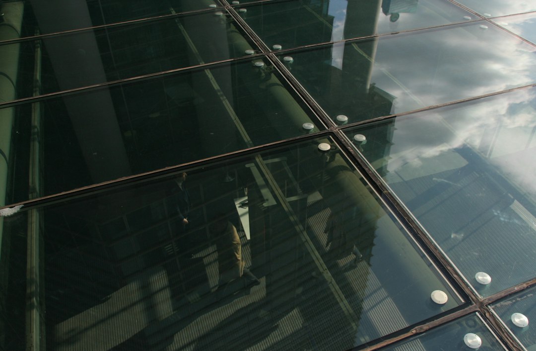 An abstract view of a modern glass skyscraper with distorted reflections, illustrating how a well-designed architecture handles the chaos of the external digital environment.