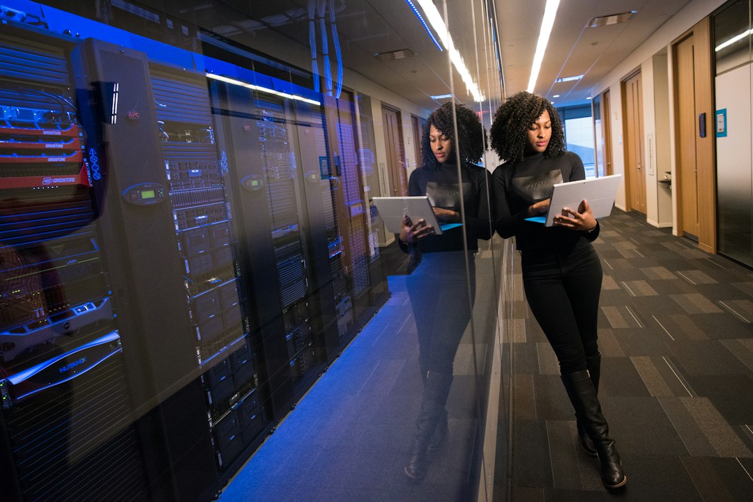 A brightly lit, minimalist view down an aisle of modern server racks in a data center, symbolizing a clean data supply chain for artificial intelligence.