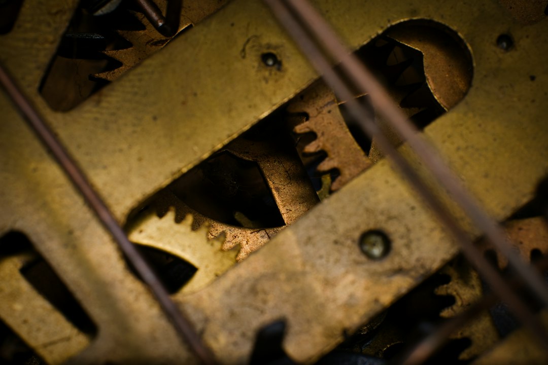A cinematic close-up of intricate, clean metal gears working together seamlessly, symbolizing a predictable and well-engineered system for revenue.