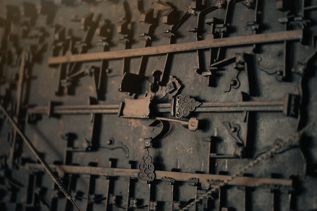 A close-up photograph of a complex and intricate metal lock mechanism, symbolizing the principles of zero-trust security, verification, and protocol.