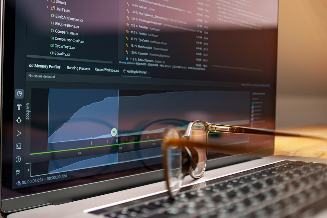 A focused individual intently analyzing complex data on a computer screen in a professional setting, representing deep industry insights.